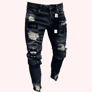 Close-up view of men's distressed skinny jeans with patches and ripped details