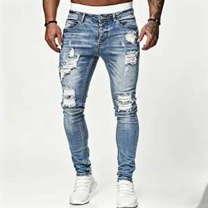 Stylish men's hip hop skinny ripped denim jeans with light blue wash and distressed details