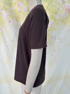 Side view of a dark brown loose-fit V-neck short-sleeve cotton T-shirt on a mannequin