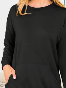 Close-up detail of a classic black long-sleeved round neck sweatshirt with front pocket
