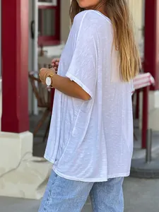 Back view of a loose white V-neck casual T-shirt showing slub texture and relaxed fit