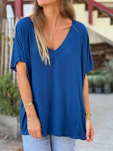 Loose-fitting royal blue V-neck T-shirt for women in a casual outdoor lifestyle setting