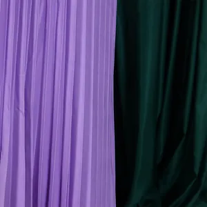 Close-up detail of high-quality purple pleated fabric texture for a summer fashion dress