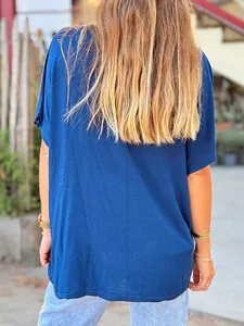 Close-up of the back of a loose-fitting navy blue women's short-sleeved cotton t-shirt.