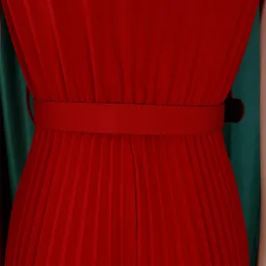 Close-up view showing the elegant fine pleats and matching belt of a red maxi dress