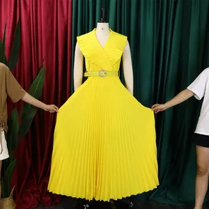 Detailed view of yellow pleated maxi dress with ruffled V-neck and matching belt.