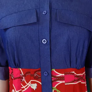 Close-up detail of denim and red printed patchwork dress showing buttons and pockets