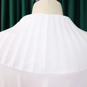 Close-up macro view showing the intricate white pleated texture and craftsmanship of the collar