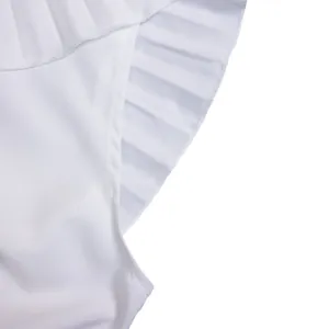 Close-up detail showing the elegant white ruffled and pleated hem of the fashion dress