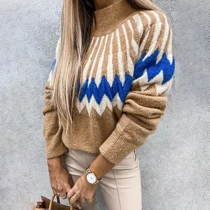 Detail of a women's high neck sweater with blue and white geometric knit patterns.