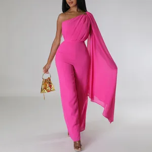 Elegant hot pink one-shoulder wide-leg jumpsuit with a dramatic draping shoulder cape