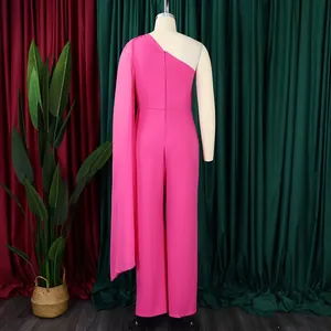 Close-up of fuchsia one-shoulder jumpsuit with elegant cape sleeve and wide leg design