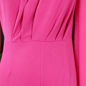 Close-up detail of pleated waist and seam on a hot pink elegant evening jumpsuit