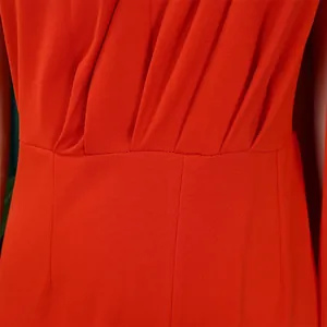 Detailed macro view showing pleated waist design of elegant orange one-shoulder evening jumpsuit