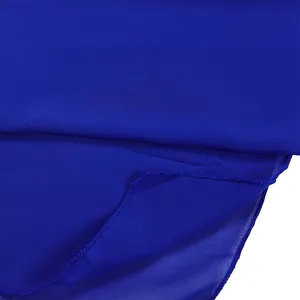 Macro view of royal blue lightweight chiffon fabric texture and finished hem detail