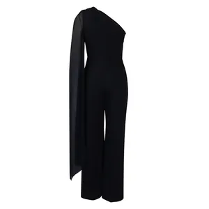 Detail view of an elegant black one-shoulder jumpsuit with long chiffon shoulder drape