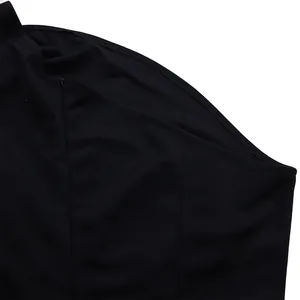 Macro detail view of the hidden zipper and side seam on a black one-shoulder jumpsuit.