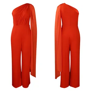 Front and back view of a vibrant orange one-shoulder jumpsuit with a long cape sleeve.