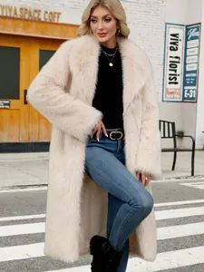 Elegant long cream faux fox fur coat for women styled in an urban winter street setting