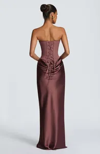 Back view of a satin floor-length gown with a corset lace-up bodice and draped skirt