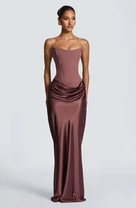 Front full-body view of a mauve strapless corset gown with elegant draped satin skirt.