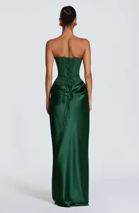 Back view of elegant dark green satin strapless gown featuring lace-up corset detail.