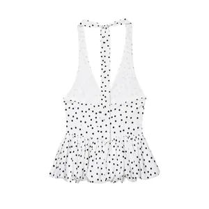 Rear view of a chic white polka dot halter neck camisole featuring tie-back and ruffled hem