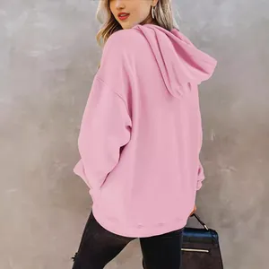 Back view of a fashionable pink oversized hoodie for women featuring a soft and cozy hood