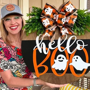 Halloween wooden door sign featuring ghosts and 'hello BOO' lettering with a bow