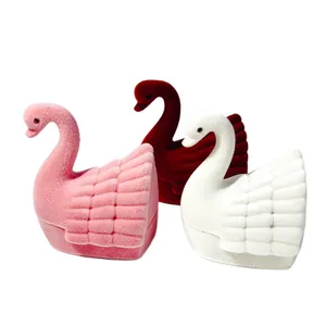 Elegant swan shaped velvet ring jewelry boxes in pink, wine red, and white colors.