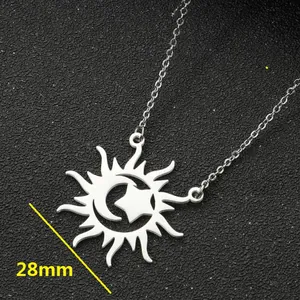 Close-up macro view of silver celestial sun moon star pendant showing 28mm width