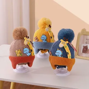 Detailed view of three colorful infant knitted earflap hats with cartoon animal patches