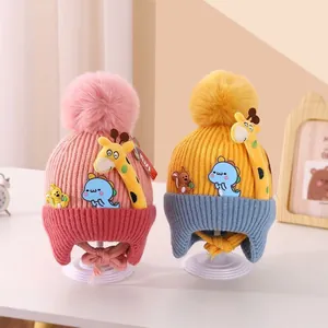 Winter knit baby hats with cute giraffe and dinosaur patches and pom-poms