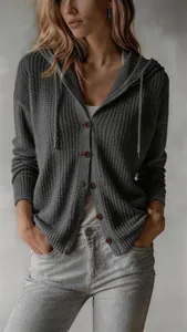 Detail shot of grey hooded knit cardigan showing button closure and texture