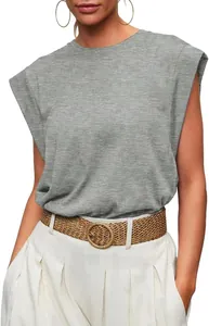 Close-up of a women's gray loose fit cap sleeve t-shirt paired with a straw woven belt.