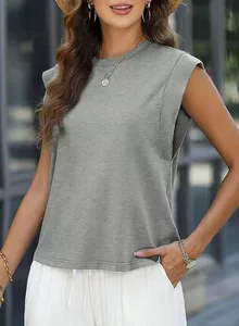 Close-up detailed view of grey sleeveless padded shoulder t-shirt on a female model