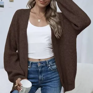 Detailed view of a brown chunky knit cardigan with lantern sleeves and relaxed fit