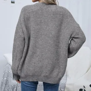 Back view of a grey chunky knit cardigan showing lantern sleeves and soft texture
