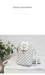 Detail view of white printed phone bag with cat-ring closure and pearl charms