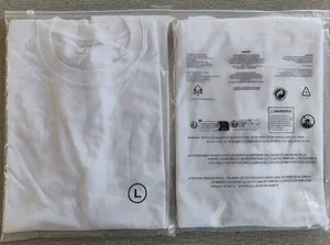 Detailed view of two white 100% cotton T-shirts neatly folded inside plastic retail packaging