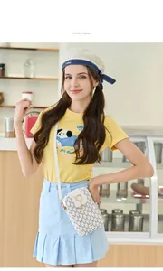 Model showing a stylish white printed crossbody phone bag with pearl charm detail