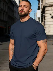 Close-up detail of a men's navy blue crew neck cotton t-shirt worn in an urban setting