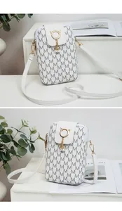 Detailed view of a white printed phone bag with cat-ear clasp and pearl charms.