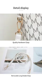 Close-up of golden hardware hook and detachable strap for white patterned bag