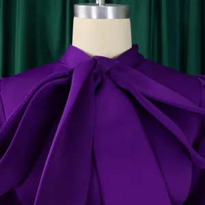 Gros plan sur le décolleté élégant à nœud papillon violet d'une robe de soirée chic