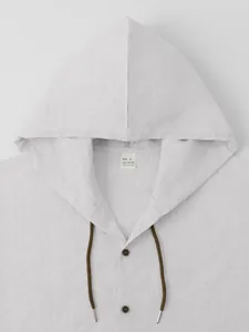 Close-up detail of men's casual white cotton linen shirt featuring hood and collar detail