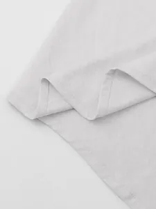Detailed close-up showing the high-quality cotton linen fabric texture on a white shirt.