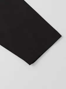 Close-up of black cotton linen shirt sleeve showing fine stitching and fabric texture