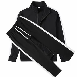 Detail view of black men's tracksuit set with white side stripes and stand collar