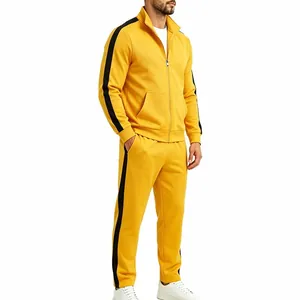 Detailed view of men's yellow sports tracksuit with black side stripes and zip-up collar.